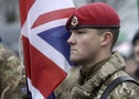 British Army soldier stands near his national flag during Latvia's Independence Day military parade in Riga