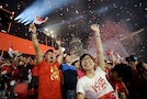 People react as confetti is released at the end of  the Singapore's Golden Jubilee celebration parade at Padang near the central business district
