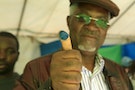 A voter shows off his inked thumb after casting vote in Rwanda's capital Kigali during a referendum