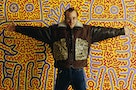 Keith Haring in Brown Coat with His Designs in Gold