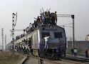 Passengers travel on an overcrowded train on the outskirts of New Delhi
