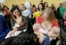Mothers breastfeed their babies during a flash mob at a children's polyclinic in the Siberian city of Krasnoyarsk, Russia