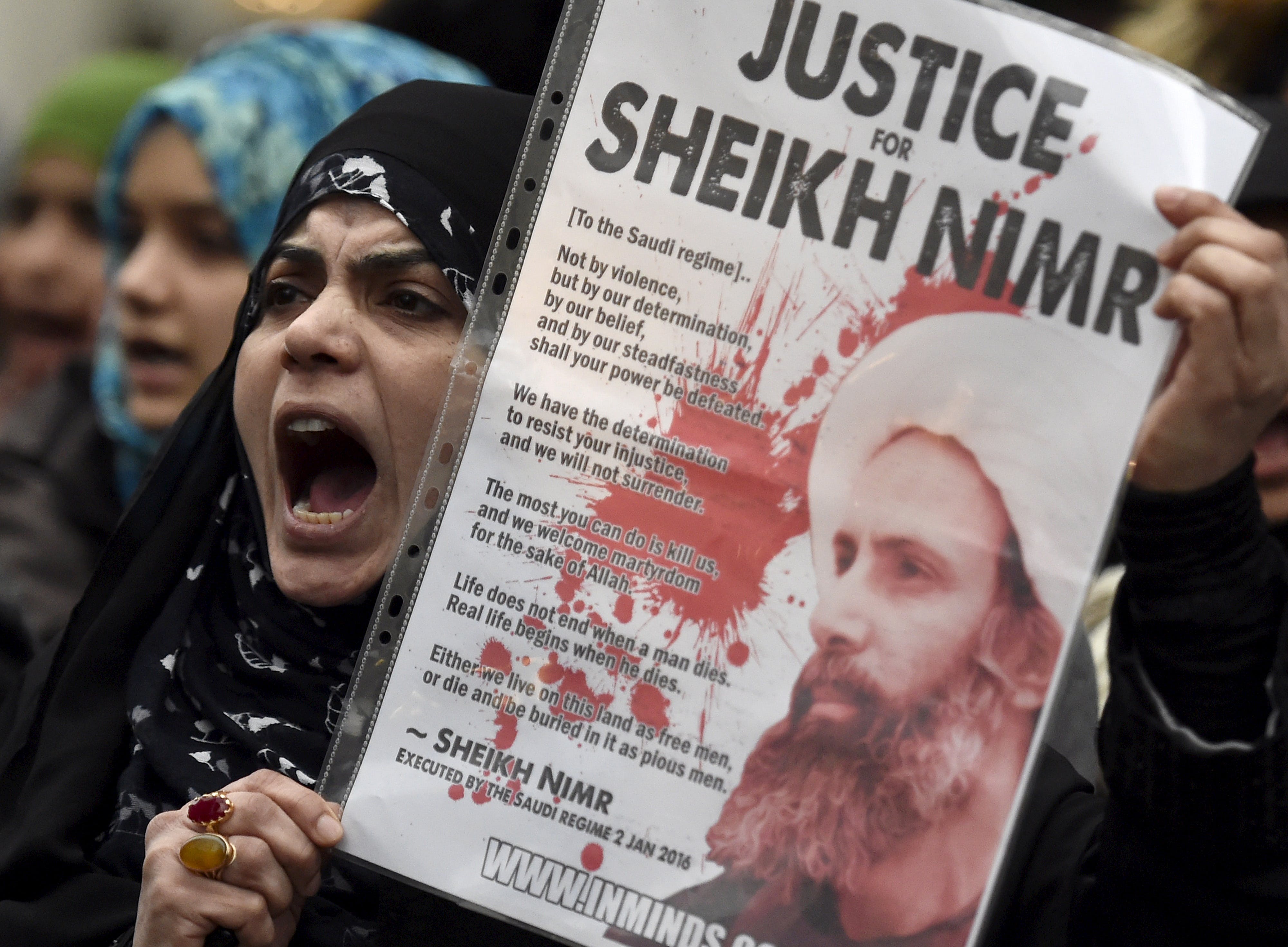 Protester holds a placard during a demonstration against the execution of Shi'ite cleric Sheikh Nimr al-Nimr in Saudi Arabia, outside the Saudi Arabian Embassy in London, Britain