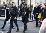 File photograph of armed police walking amongst shoppers along Oxford Street in London