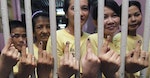 Filipino inmates show their fingers with indelible ink after voting inside a jail in Makati city, metro Manila May 10, 2010. Inmates in the Philippines are allowed for the first time to exercise their rights to vote inside their prison cells. More than 50 million people are eligible to vote for nearly 18,000 local and national positions, and authorities expect a voter turnout of more than 80 percent. . REUTERS/Romeo Ranoco (PHILIPPINES - Tags: POLITICS ELECTIONS IMAGES OF THE DAY) - RTR2DOO3
