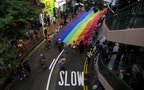 Participants hold a giant rainbow flag during a lesbian, gay, bisexual and transgender (LGBT) Pride Parade in Hong Kong