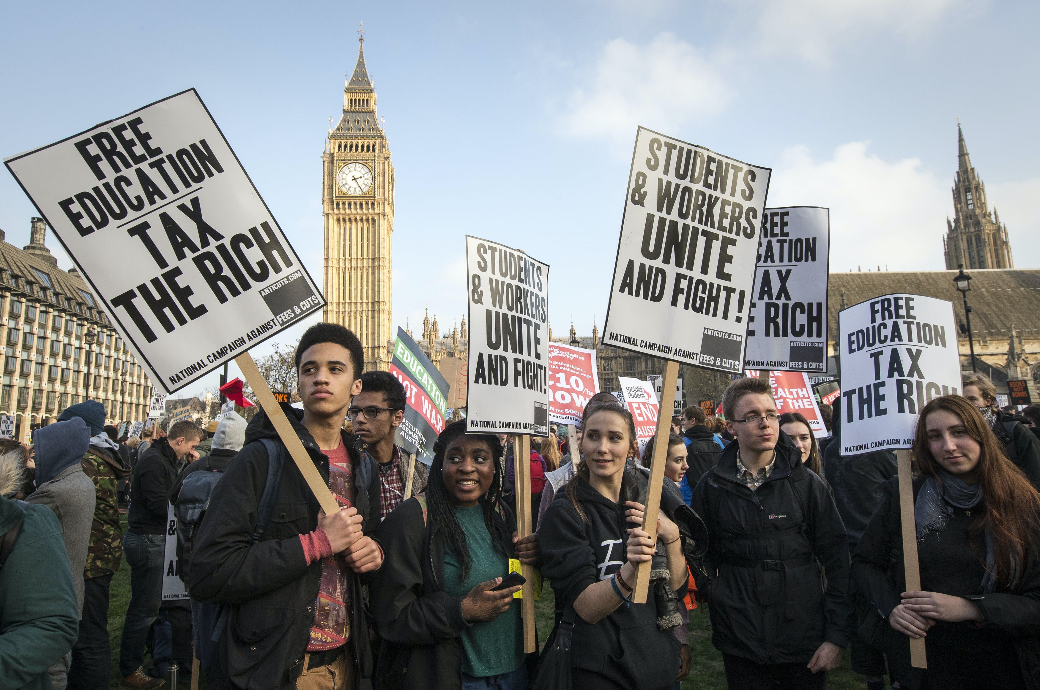 Demonstrators stand in Parliament Square in front of the Houses of Parliament during a protest against student loans and in favour of free education, in central London