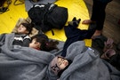 Children sleep on the deck of the rescue ship "Aegis 1" near the Greek island of Oinousses