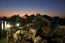 A 17-storey apartment building which collapsed after an earthquake is seen during sunset in Tainan