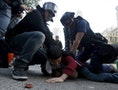 A protester is arrested by riot police at Mongkok district in Hong Kong
