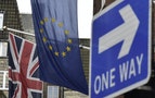 A British Union flag and a European Union flag hang from a building in central London