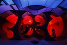 A visitor sits on Verner Panton's " Phantasy Landscape" which is made of fabric, wood and foam rubber, at the Tokyo Opera city art gallery in Tokyo
