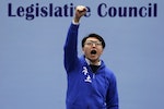 梁天琦Edward Leung, a candidate from the Hong Kong Indigenous, chants slogans on the podium before the final poll result is announced in Hong Kong