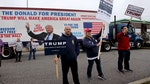 Supporters of U.S. Republican presidential candidate Donald Trump hold up signs to drivers as they pass by on Super Tuesday in Middleburg Heights