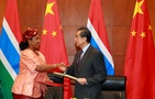 China's Foreign Minister Wang Yi (R) shakes hand with his Gambian counterpart Neneh Macdouall-Gaye at a signing ceremony in Beijing