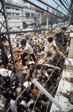 1975年4月29日，美軍撤離越南，大量的越南民眾在美國大使館圍牆外聚集，嘗試翻過圍牆，冀求離開越南。Photo Credit：Corbis/達志影像