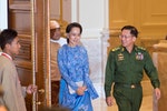Aung San Suu Kyi (C) and Myanmar Military Chief Senior General Min Aung Hlaing arrive (R) for the handover ceremony from outgoing President Thein Sein and new Myanmar President Htin Kyaw at the presid