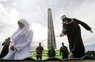 Murni Amris, an Acehnese woman, is caned as part of her sentence in the courtyard of a mosque in Aceh Besar district