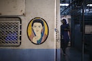 A portrait of a woman is seen near the entrance of the female compartment of a suburban train in Mumbai