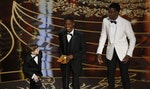 Host Rock brings apple boxes for young presenters Tremblay and Attah to reach the microphone at the 88th Academy Awards in Hollywood