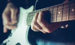 Young man playing electric guitar. Music, instrument education, entertainment, rock star, music concert and learning concept