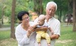 Chinese grandfather and grandmother playing with baby grandson at outdoor
