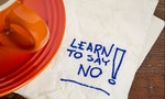 learn to say no advice - handwriting on a napkin with cup of coffee