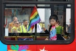 Los Angeles County Sheriff's deputies are seen behind a girl riding in a bus at the 46th annual Los Angeles Gay Pride Parade in West Hollywood