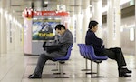 TOKYO - NOVEMBER 30: worker men waiting subway early morning and falling asleep on chairs on November 30, 2011 in Tokyo, Japan.