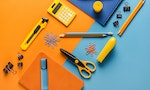 Composition of orange and blue school supplies with calculator — Photo by VadimVasenin
