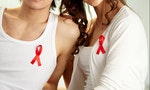 Close up of couple wearing red ribbons indicating their support for AIDS campaign-2015
