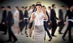 Young blindfolded woman. seeking a way out in a crowd