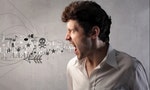 Angry man screaming with symbols and words coming out of his mouth