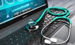 Creative abstract healthcare, medicine and cardiology tool concept: laptop or notebook computer PC with medical cardiologic diagnostic test software on screen and stethoscope on black wooden business 