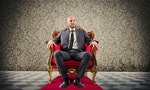 Successful businessman sitting on a royal armchair