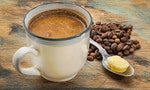 a cup of fresh fatty coffee with butter and coconut oil - ketogenic diet concept