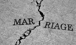 Symbol of broken marriage with crack in concrete and word