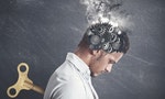 Concept of stress with gear in the head of a businessman