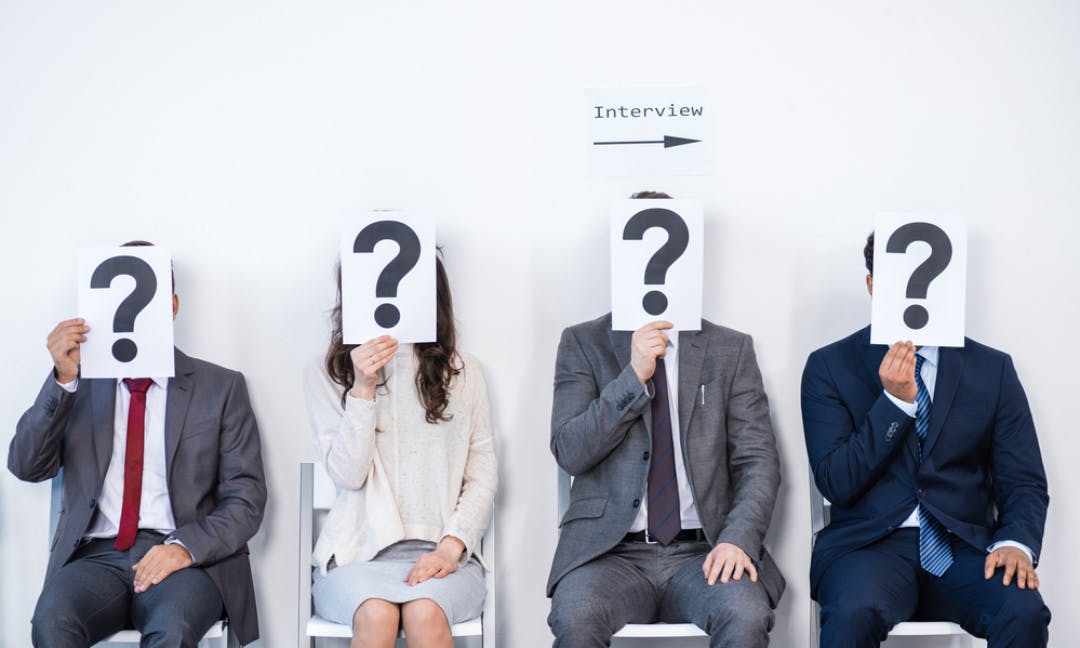 Businesspeople sitting in queue and waiting for interview, holding question marks in office, business concept — Photo by DmitryPoch