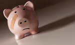 Piggy Bank with Bandage on Face on Dramatic Gradated Background.