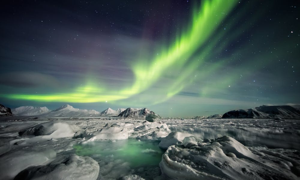 Natural phenomenon of Northern Lights (Aurora Borealis) related to the earth's magnetic field, ionosphere and solar activity. Arctic winter landscape. — Photo by erectus