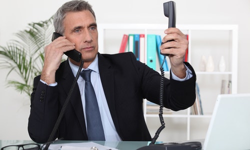 Businessman on two telephone calls