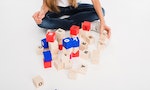 Cropped view of child playing with alphabet blocks, isolated on white — Photo by IgorVetushko