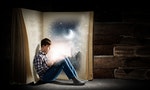 Teenager boy wearing jeans and shirt and reading book