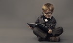 Boy in glasses reading book, smart little child study lesson, education concept