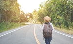 Happy Asian girl backpack in the road and forest background, Relax time on holiday concept travel ,color of vintage tone and soft focus - 圖片