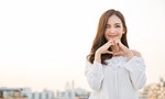 Portrait of young beautiful asian woman hands gesture in heart shape on city sky roof top. Smile face asian girl wear casual cloth. Japanese girl lifestyle, lovely woman valentines’ day concept - 圖片