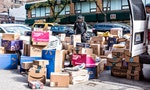 New York City, USA - October 30, 2017: Delivery man with many boxes in NYC by BH photo video store, van truck unloading amazon prime, walmart, chewy, blue apron  A