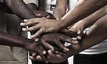 Closeup portrait of group with mixed race people with hands together