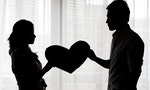Troubled couple holding a heart shape,silhouette